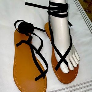 Black tie up gladiator sandals.